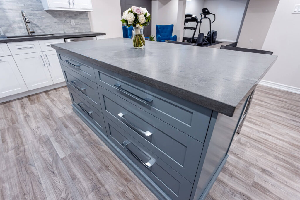 grey island with drawers for storage space and grey marble countertop